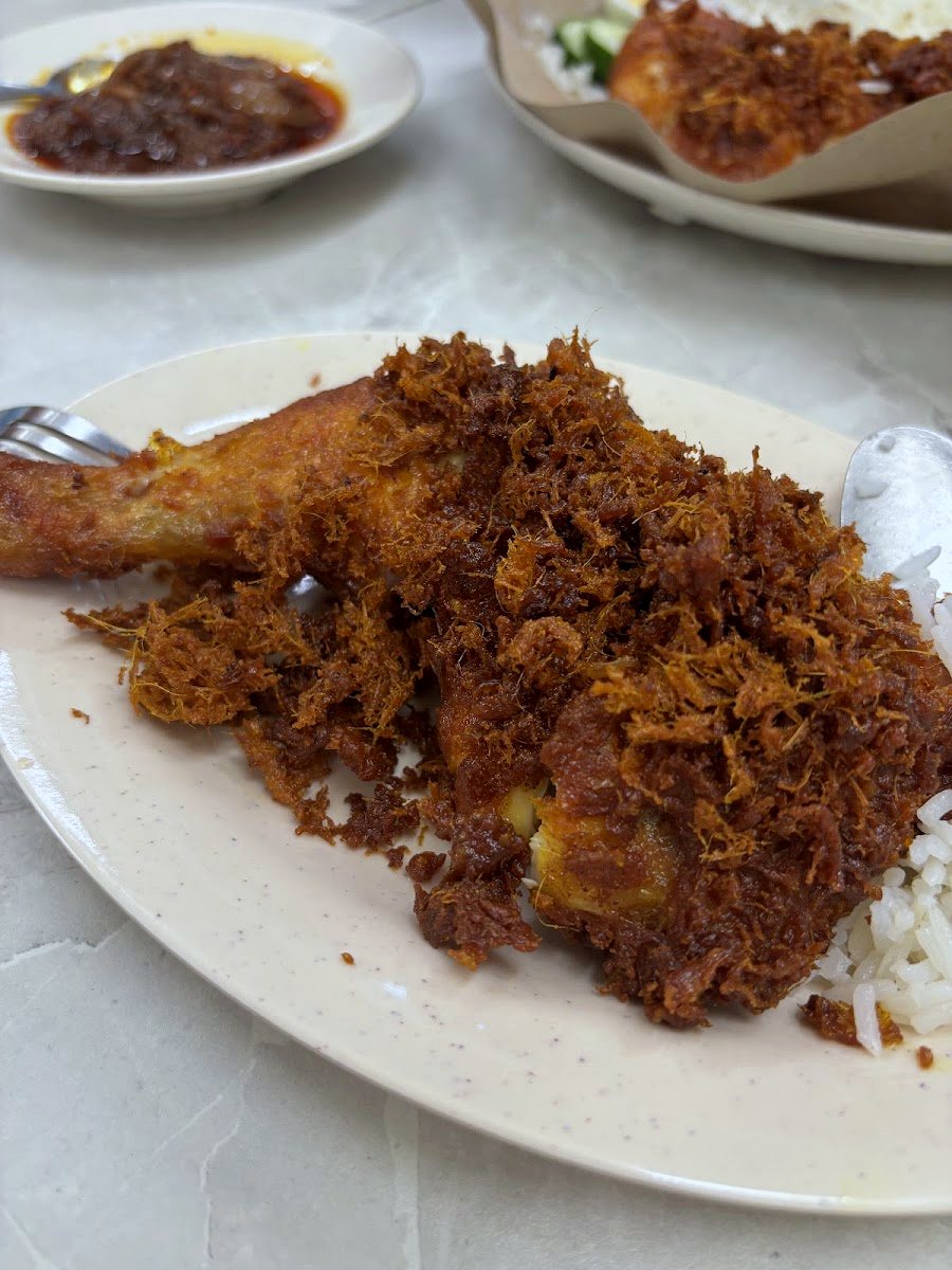 A plate of crispy Taiwanese Fried Chicken served with rice and a side salad.